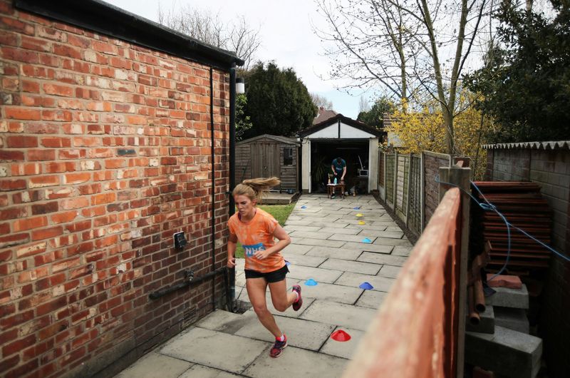 Social distancing photos - woman running a marathon in her yard