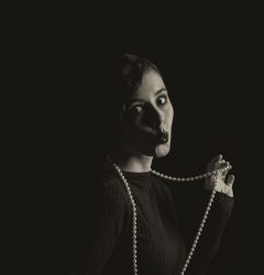 instagram alt text woman in the dark with pearls