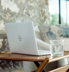 digital marketing things - laptop and glass of water on little wooden table