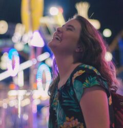 being authentic - woman laughing at theme park at night