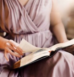 stories vs case studies - woman in pink dress reading a book
