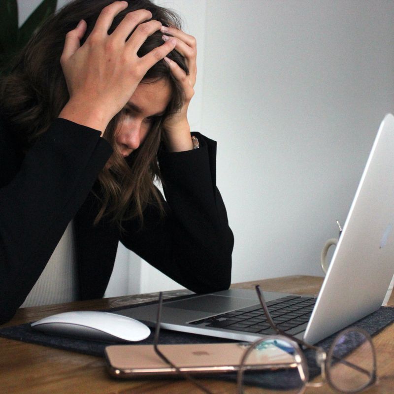 how stressful is a google search algorithm update - girl with hands in her head at a desk in front of a laptop