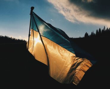 help ukraine - ukrainian flag at dusk