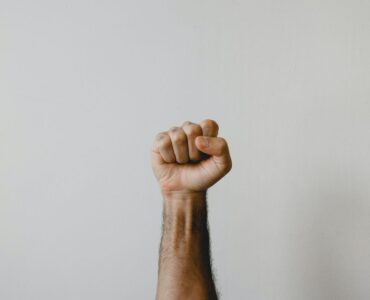 fist pointing to the sky - muse creative awards